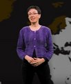 Lady speaking and standing in front of a map of the Nordics