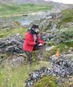 Woman out in the nature climbing uo a cliff/hill