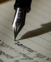 Ink pen writing on a notepad