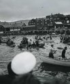 Hunt for pilot whales at the habour. People standing and sitting in each of their kayak