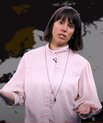 Woman standing and talking in front of a map of Europe.